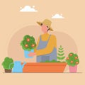 Gardener tending flowers. Floriculture. Man caring flower bed using gardening tools: watering can, pot. Royalty Free Stock Photo